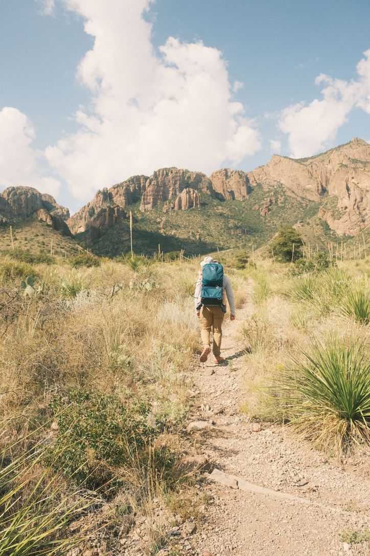 Miguel hiking in the Chisos Basin, Big Bend National Park, carrying his child
