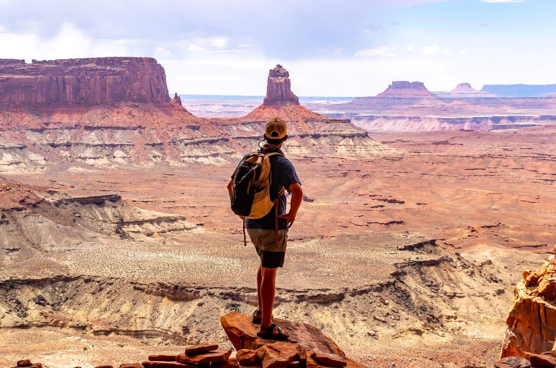 Miguel standing at the rim looking out over Canyonlands National Park